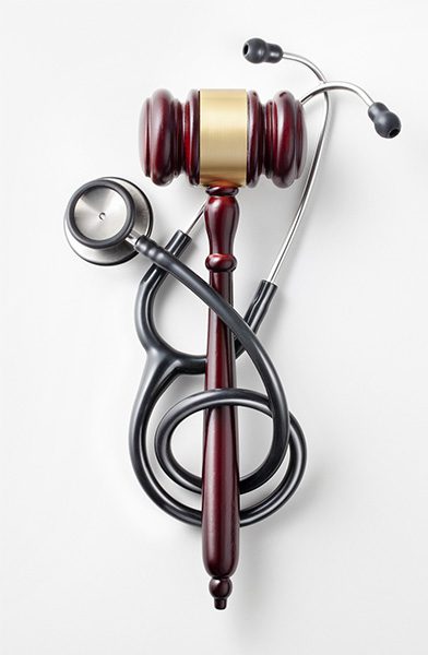 Gavel with Stethoscope on White Background